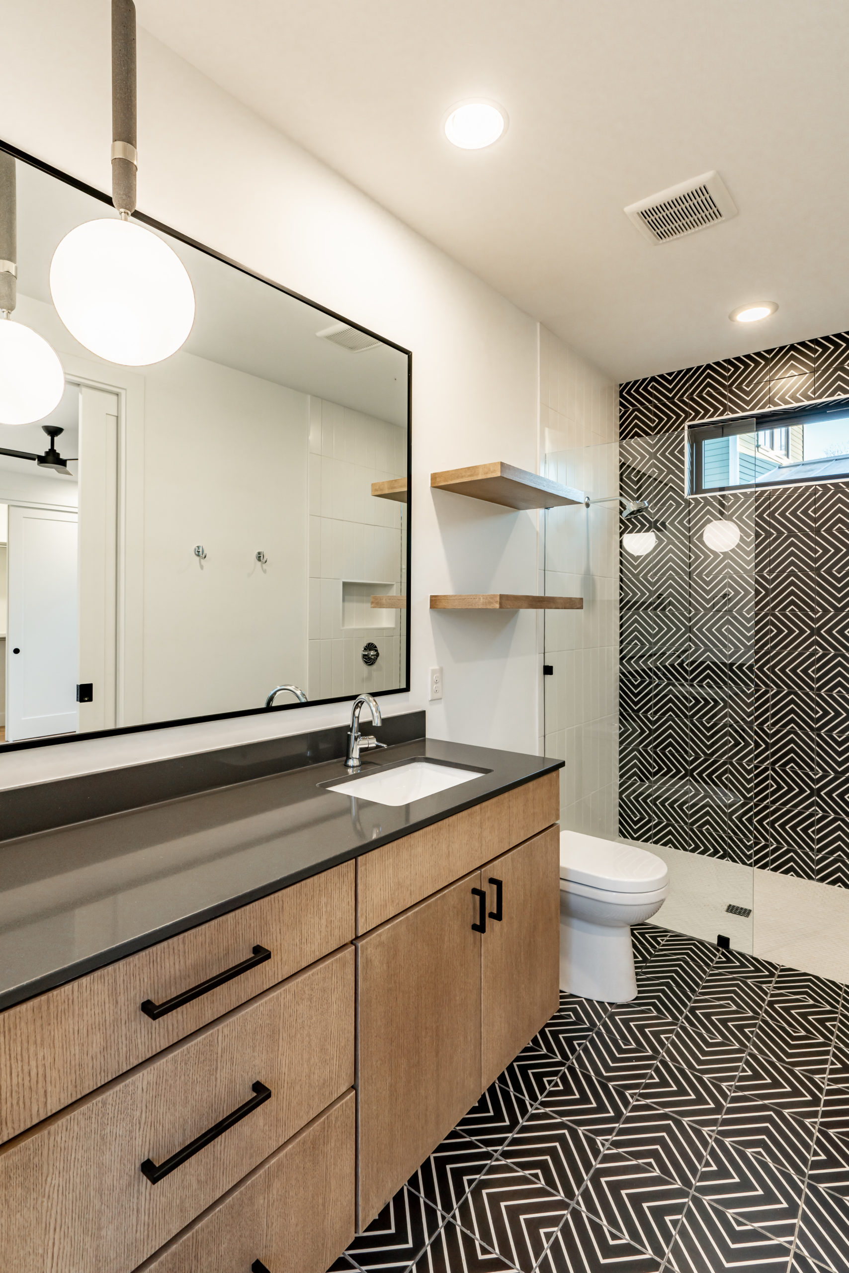 Woodview Custom guest bathroom featuring designer tile and plumbing