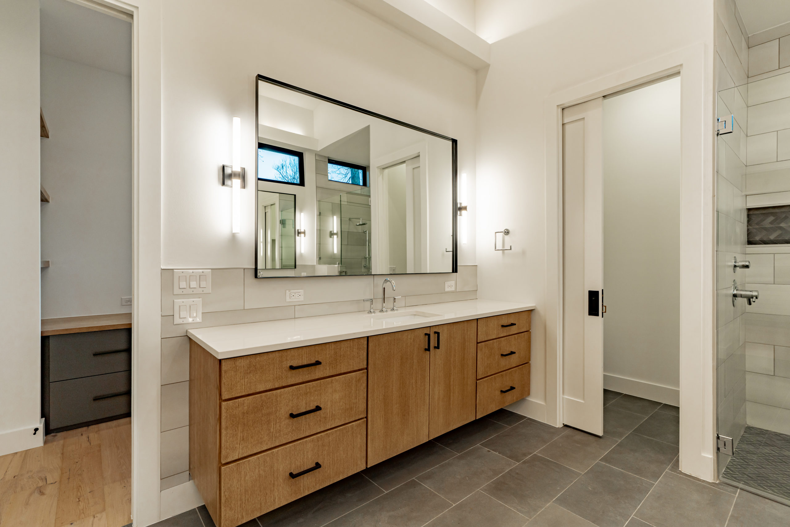 Woodview custom master suite shower dual vanities with designer lighting, plumbing and tile