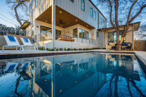 Pool and outdoor entertainment living area at Zilker, Austin custom home