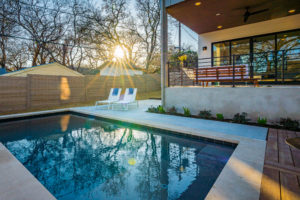 Pool and outdoor entertainment living area at Zilker, Austin custom home