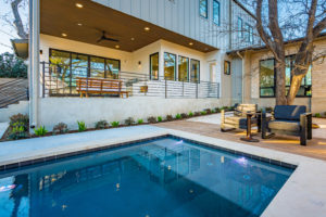 View of the back patio from the pool at 2007 De Verne custom home