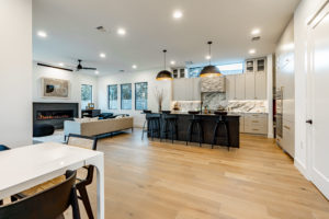 Open plan living, dining and kitchen at 2007 De Verne custom home