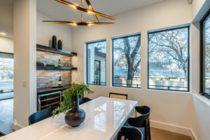 Dining room with dry bar, wine cooler and chandelier at Zilker custom home