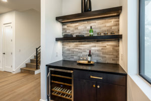 Dry bar with integrated wine fridge and soapstone countertop at Zilker custom home