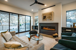 Custom soapstone fireplace and luxurious four part sliding door at Zilker custom home
