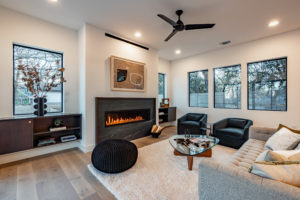 Custom soapstone fireplace and designer built in cabinetry at 2007 De Verne custom home