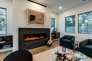 Custom soapstone fireplace and designer built in cabinetry at 2007 De Verne custom home