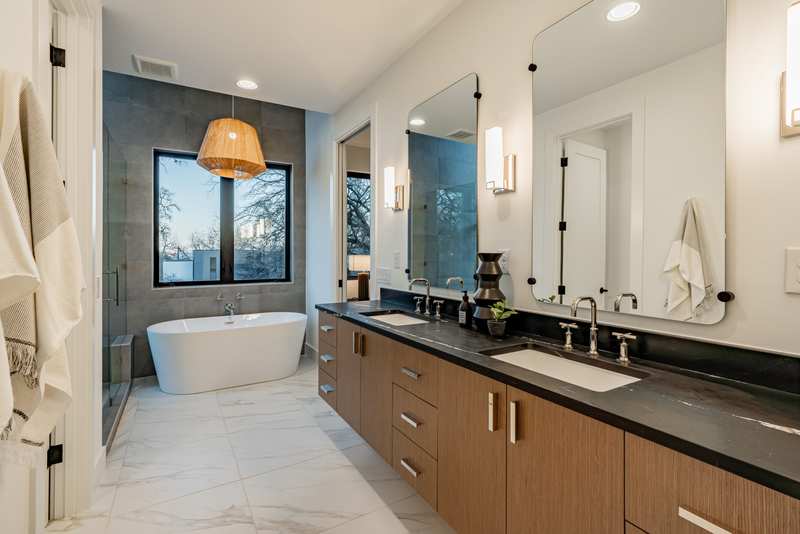 Soaking tub and vanity in luxury master suite at Zilker custom home