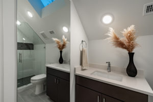 Third floor full bathroom with skylight at 2007 De Verne custom home