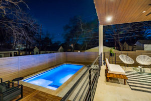 Pool and outdoor entertainment living area at Zilker, Austin custom home