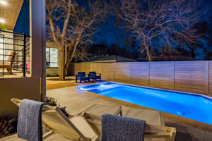 Pool and outdoor entertainment living area at Zilker, Austin custom home