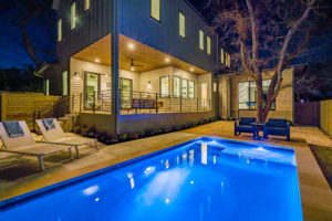 Pool and outdoor entertainment living area at Zilker, Austin custom home